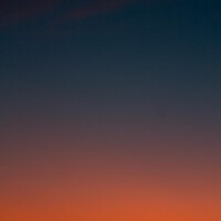 Fiery sunset with crescent moon Crescent moon and fiery orange sunset horizon